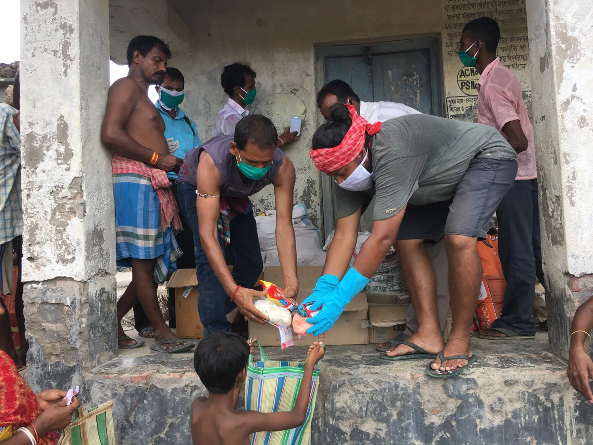 Saurav Moni and others supplying food to villagers after Cyclone Amphan