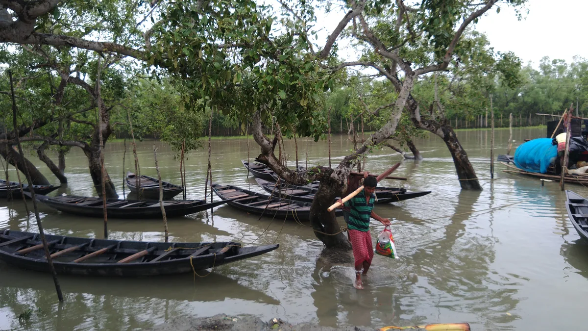 Boatman anchoring a boat in the river
