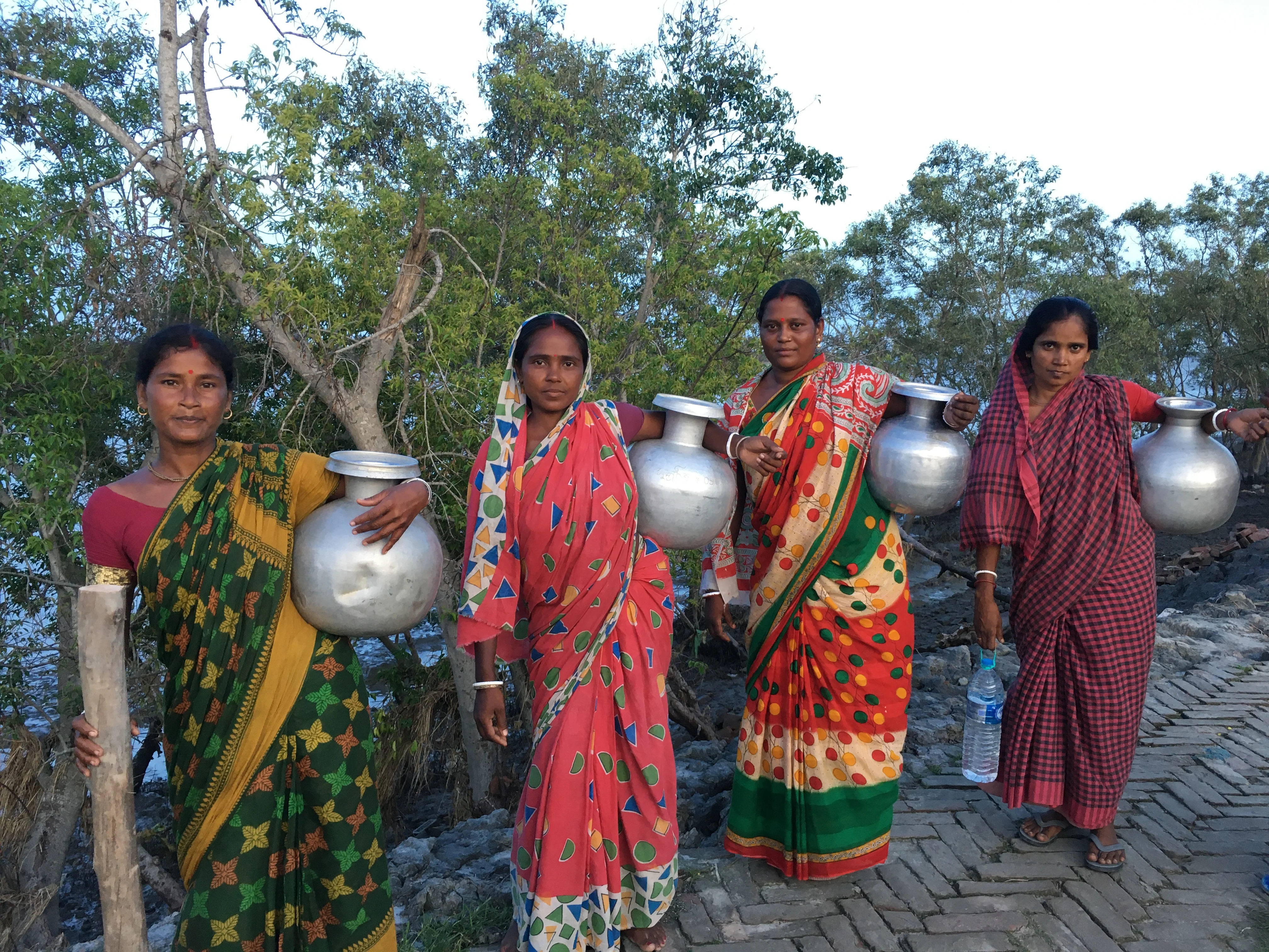 Women carrying large water pots